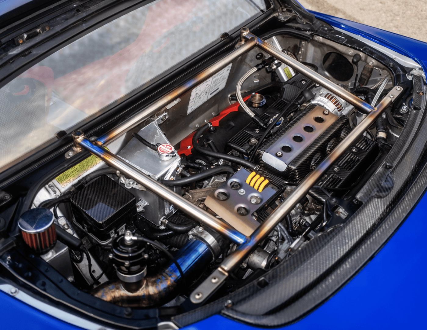 Turbocharged 3.0-liter V6 engine bay with titanium chassis bars
