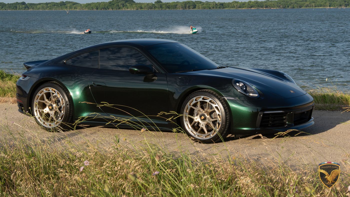 911 Carrera T in low evening light beside tall grass