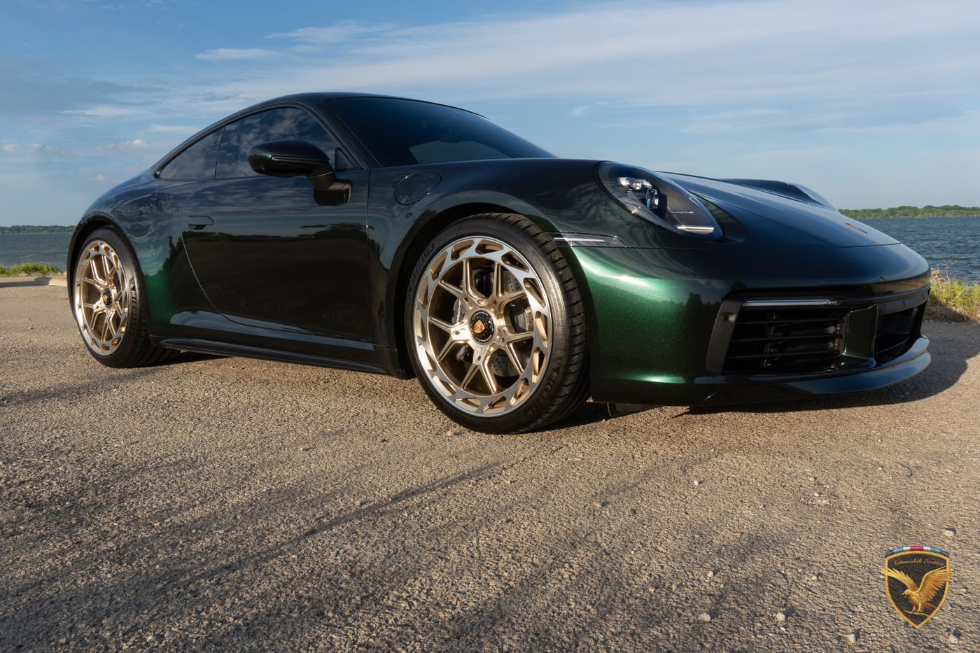 Low front three-quarter view of the 911 on gold wheels