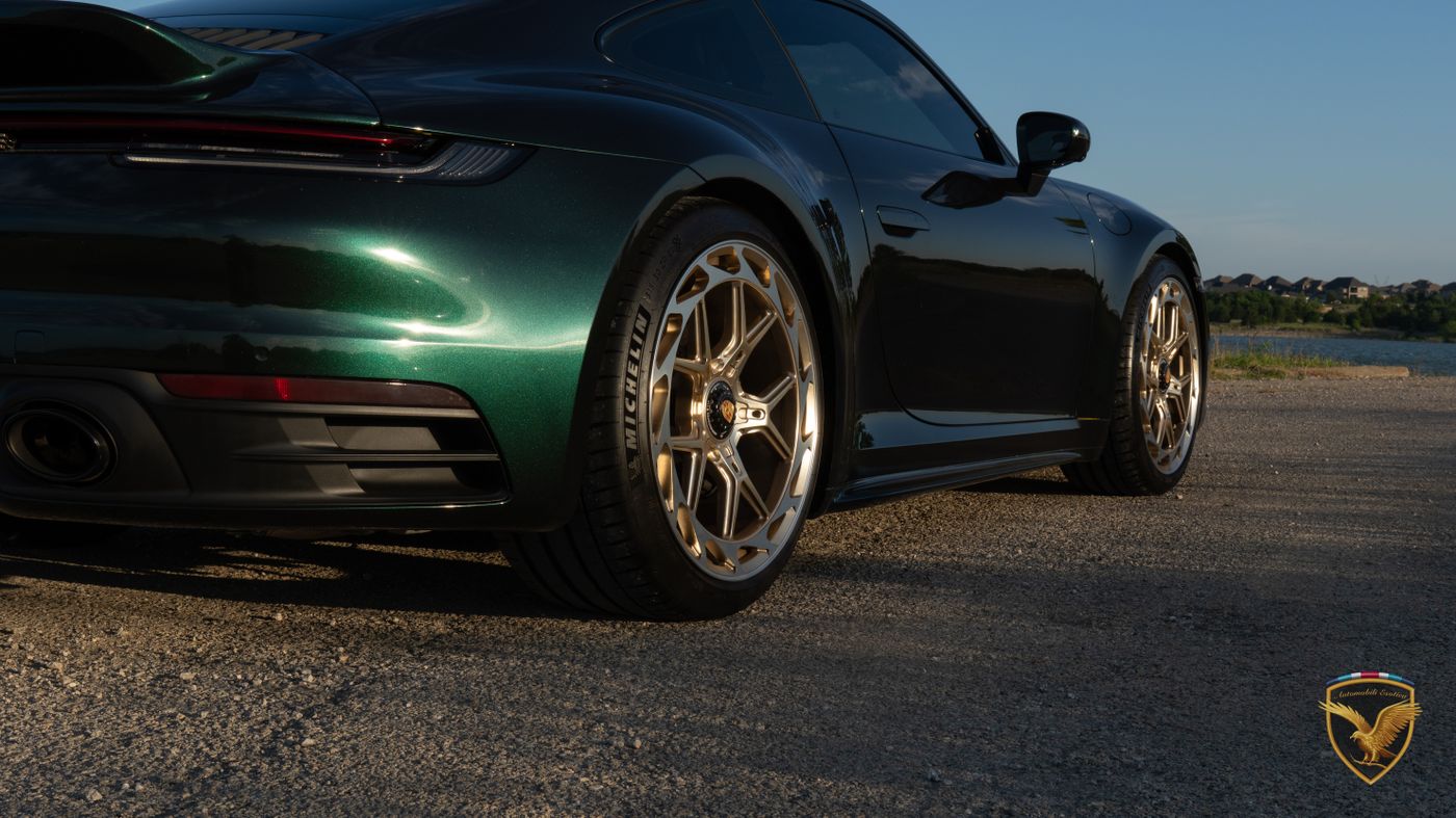 Close-up of the 911's frozen gold wheel and green wrap